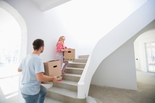 Packed moving boxes ready for transportation by a man with van