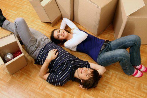 Mover carrying boxes down stairs in a conversion flat